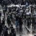 SURABAYA, INDONESIA - MARCH 24: Activists clash with Indonesian Police officers during a protest against the military law revision on March 24, 2025 in Surabaya, Indonesia. On March 20, Indonesia's House of Representatives passed a revision to military law, allowing military officers to serve in more government posts and take up civilian positions without resigning from the Indonesian National Armed Forces. This amendment has drawn criticism from civil society groups, who warn it could signal a return to the repressive New Order era under former President Soeharto, when military officers dominated civilian affairs.Critics argue that this change could lead to abuse of power, human rights violations, and political impunity for army personnel, reminiscent of the era under dictator Suharto, who stepped down in 1998. The timing is particularly significant as Indonesia is now led by President Prabowo Subianto, an ex-special forces general and former son-in-law of Suharto, who was inaugurated in October 2024. (Photo by Robertus Pudyanto/Getty Images)