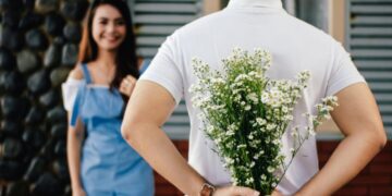 Photo by Vija Rindo Pratama: https://www.pexels.com/photo/man-holding-baby-s-breath-flower-in-front-of-woman-standing-near-marble-wall-935789/