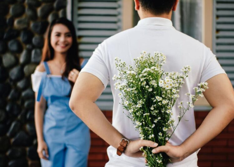 Photo by Vija Rindo Pratama: https://www.pexels.com/photo/man-holding-baby-s-breath-flower-in-front-of-woman-standing-near-marble-wall-935789/