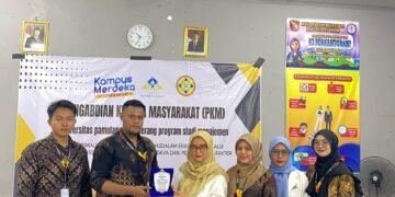 Penyerahan plakat oleh tim Pengabdian Kepada Masyarakat Universitas Pamulang kepada pihak SMKN 1 Ciruas sebagai bentuk apresiasi dan kerja sama dalam kegiatan sosialisasi literasi dan inklusi keuangan