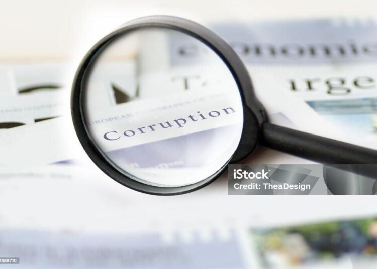 Corruption news concept showing a printed newspaper with a magnifying glass
