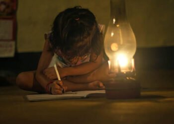 Village Girl reading book in lighting lamp