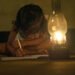 Village Girl reading book in lighting lamp
