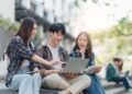 Hubungan Penggunaan Media Sosial Dengan Kebiasaan Prokrastinasi Akademik Mahasiswa 56 Beautiful young Asian woman college student with friends at outdoors. College student working on the college campus