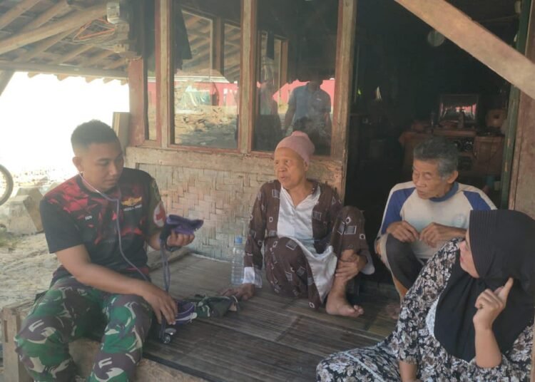 Anggota tim kesehatan Satgas TMMD Ke-129 Kodim 0601/Pandeglang memberikan pemeriksaan kesehatan kepada seorang lansia di Desa Pasirgadung, Kecamatan Patia, Kabupaten Pandeglang.